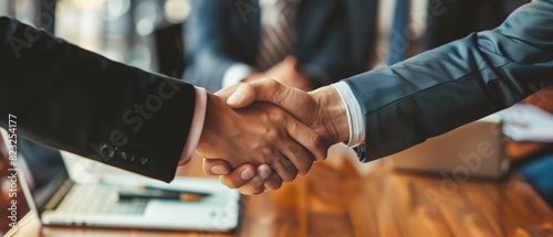 Businessmen shaking hands across a conference table