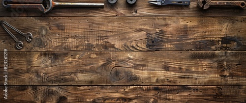 Top view flat lay of building tools on a wooden table with copy space. The banner design highlights various construction tools, emphasizing craftsmanship and DIY projects.