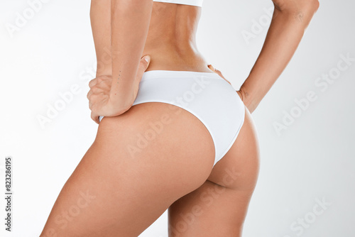 Woman, butt and underwear with skincare in studio for beauty, lingerie and wellness for dermatology treatment. Person, healthy and smooth skin with spa care of natural body on white background