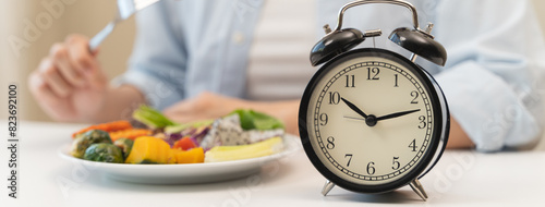 Intermittent fasting concept, Close-up on clock and people feeling hungry waiting time to eat during intermittent fasting diet session