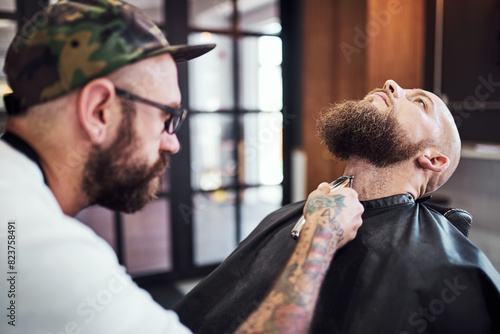 Beard, shave and man in barbershop with machine, client and tools for trendy facial cut at small business. Style, barber and customer in chair for grooming service, haircut skills and clean trim