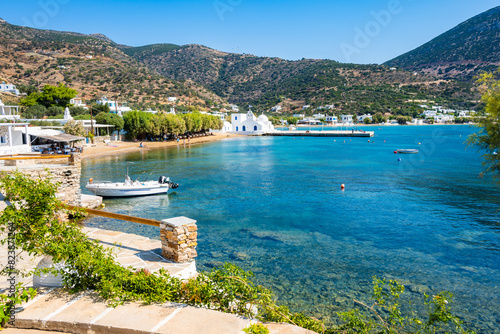 View of azure sea bay and fishing boat in Platis Gialos village port, Sifnos island, Greece
