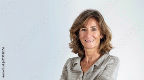 portrait of a smiling Mature brunette businesswoman looking at the camera on white background
