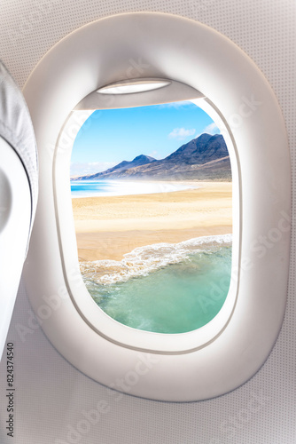 Beautiful view of a tropical beach from the airplane window. - Summer vacation concept. 
