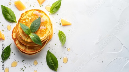 Pancakes with cheese and basil leaves