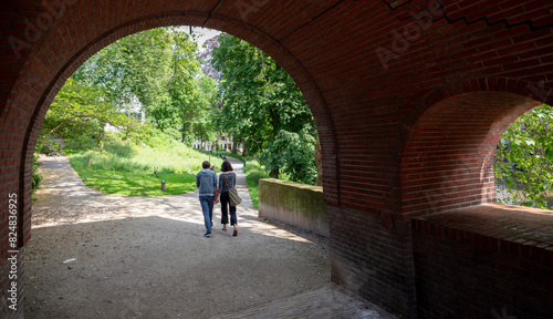 couple walks in park manenburg near old city center of utrecht in the netherlands