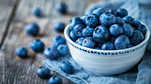 Handful of blueberries in a white bowl, deep blue color, close-up shot, fresh and nutritious, perfect for snacking, rustic wooden background, copy space.