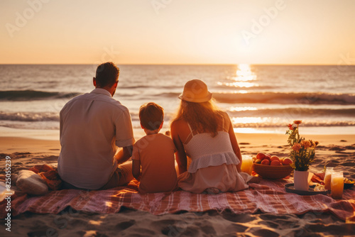 Family enjoying a picnic on the beach at sunset, sitting on a blanket with a picturesque ocean view, creating cherished moments together.