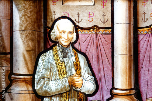 A stained glass of Saint Jean Marie Vianney. Notre-Dame de La Salette, France. Vitrail de Saint Jean Marie Vianney, Curé d'Ars. Sanctuaire de Notre-Dame de La Salette.
