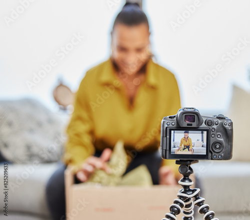 Camera, screen and woman with box for vlog as influencer for social media, campaign and project. Creativity, online vlogger and content creator with brand promotion or podcast and unboxing gift