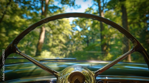 Vintage car steering wheel with a view of an autumn forest path for travel or nature themed designs