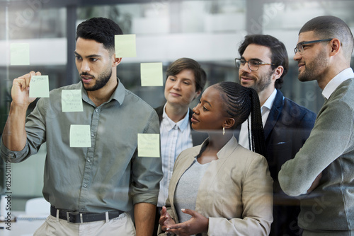 People, employee and glass board for strategy with teamwork, collaboration and planning. Brainstorming, ideas and vision or mission for project at workplace with sticky notes for solution and agenda