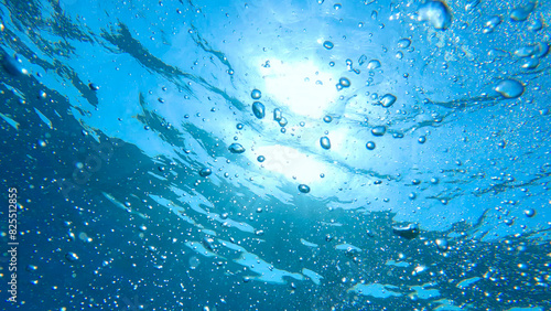 UNDERWATER: Crystal clear blue water with bubbles rising towards the sunlight. The shimmering light rays create a serene and tranquil atmosphere. Beauty and tranquillity under the azure Adriatic Sea.