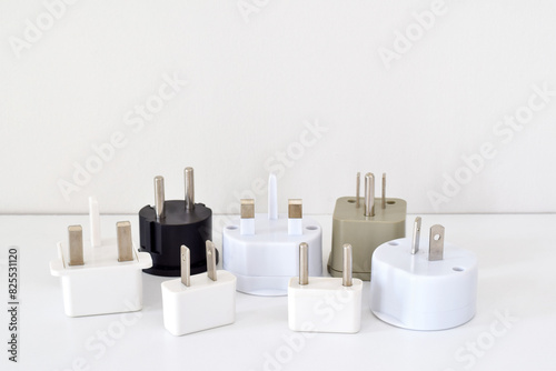 A group of travel power adapters on white background