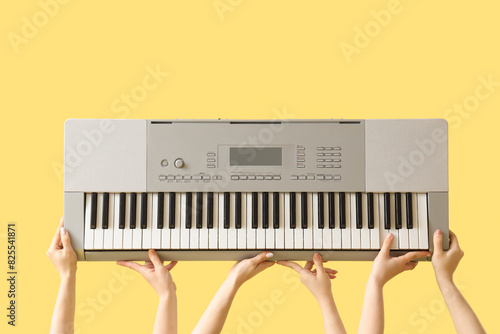 Women with synthesizer on yellow background