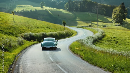 A classic coupe driving along a winding country road