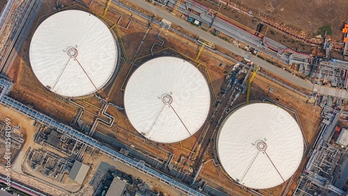 Aerial top view oil terminal storage tank at night.