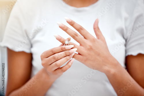 Hands, divorce and woman remove wedding ring for cheating, infidelity or toxic marriage problems. Argument, upset and closeup of female person taking off engagement jewelry for relationship breakup.