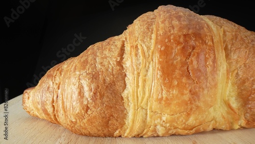 A croissant is a buttery, flaky, crescent-shaped pastry that originated in France. It is made from layered yeast-leavened dough, which is folded and rolled several times in succession. Food concept. 