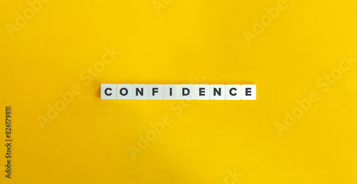 Confidence Word and Banner. Concept of developing a sense of self-assurance and belief in one's own abilities, qualities, and judgment. Text on Block Letter Tiles on Yellow Background.