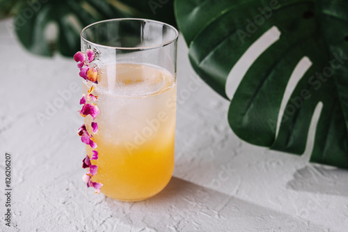 Tropical cocktail with orchid garnish