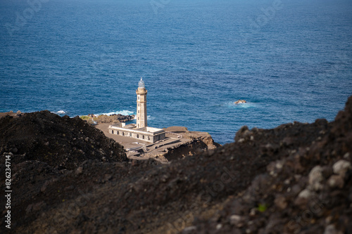 Farol da Ponta dos Capelinhos lighthouse at Faial island of the Azores, Portugal. Former beacon on the Atlantic Ocean coast. Eruption of Capelinhos volcano.