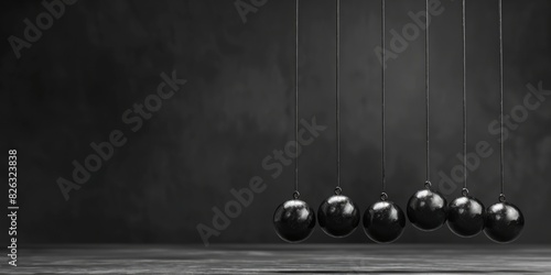 A group of pendulums hanging from strings. Ideal for science and physics concepts