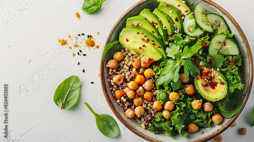 Bowl of quinoa salad with avocado and chickpeas on a white background