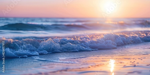 A serene ocean sunset with bokeh waves gently lapping against the shore.