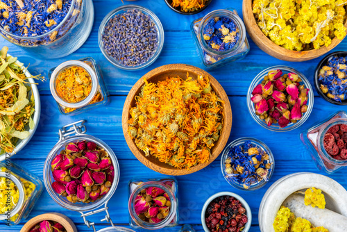 Assortment of dry herbal and berry tea on a wooden background. Tea party concept. medicinal herbs. Healing herbs.Alternative medicine.Linden, calendula, cornflowers, marigold, tansy, tea rose.
