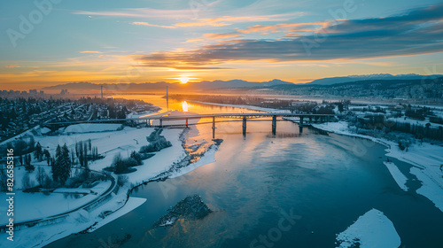 Vancouver, British Columbia, Canada - February 22, 2018: Aerial view of Fraser River and Port Mann Bridge during a vibrant winter sunset.