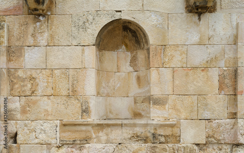 Old stone wall with a niche