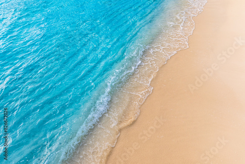Closeup of waves sand beach and blue summer sea. Panoramic beach landscape. Mediterranean tropical shore seascape. Blue sky, soft sand, calm, tranquil relax sunlight, summertime mood. Travel vacation