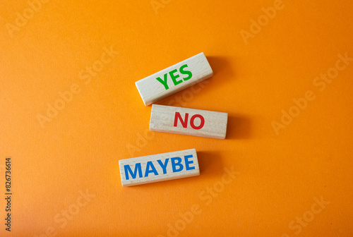 Yes No Maybe symbol. Concept word Yes No Maybe on wooden blocks. Beautiful orange background. Business and Yes No Maybe concept. Copy space.