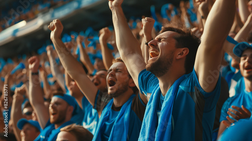 cheering soccer supporters blue shirt in soccer stadium