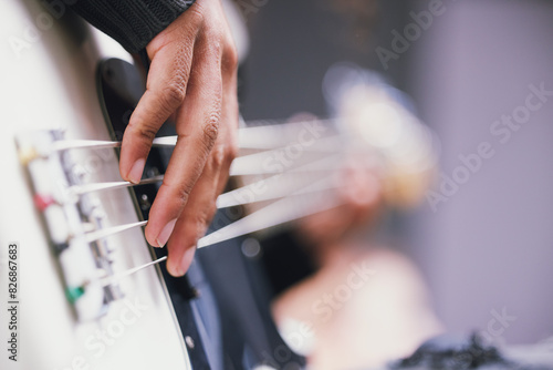 Hand, bass guitar and music in studio for process, mixing or rehearsal for performance. Person, artist or musician at sound check with audio technology, creativity and art at record label with talent