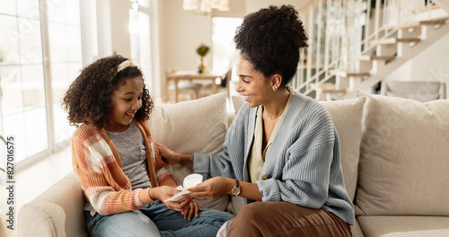 Sanitary, towel and pad with mother for menstruation knowledge for girl child, explain and awareness for growth or development. Mom, kid and talk on sofa for hygiene education or reproductive health.