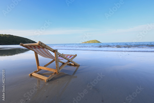 Wooden lounge chairs on a beautiful tropical beach