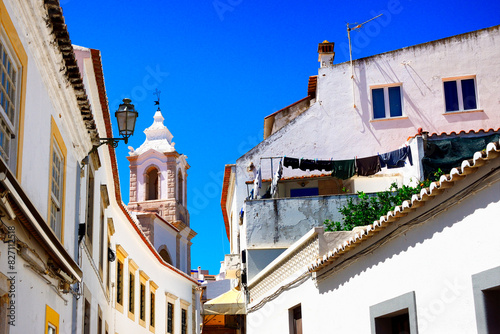 Rua Henrique Correia da Silva, belltower of Santo António church in background, historic old town of Lagos, Algarve, Portugal, Europe