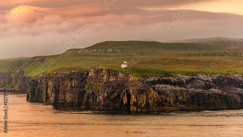 Faroe Islands, Bordan lighthouse, Nolsoy island. Panoramic with gorgeous sunset over fjords landscape and seascape.