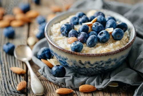 Healthy breakfast. oatmeal porridge with blueberries and almonds on wooden table background