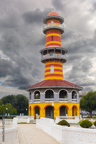 View on colorful Sages Look-out or Ho Withun Thasana under heavy gray rain clouds at Bang Pa-In Palace Ayutthaya Thailand. Is observatory tower build in 1881 for viewing the surrounding landscape.