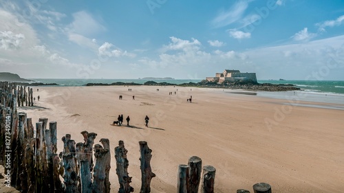 People strolling on the beach by the sea in Saint-Malo, Bretagne, France