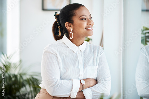 Business woman, happy or thinking with arms crossed in office for corporate growth and work goals. Female person, idea or vision looking out window with hope, confidence and smile at career progress