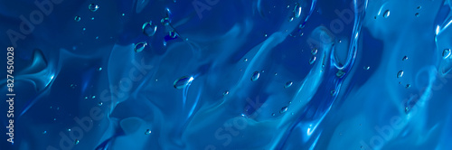 Close up gel texture of cosmetic products. transparent cream on a dark blue background with bubbles. macro photo. blur and selective focus. Long banner.