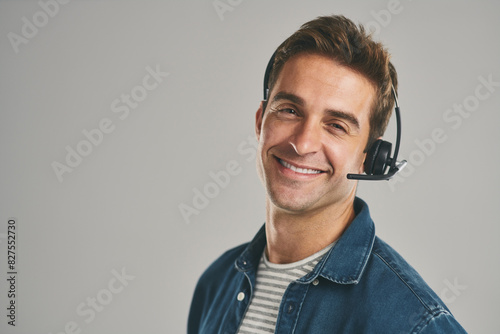 Man, portrait and headset for call centre for customer service on grey background, contact us or mockup. Male person, face and studio or crm help desk for telemarketing, technical support or hotline