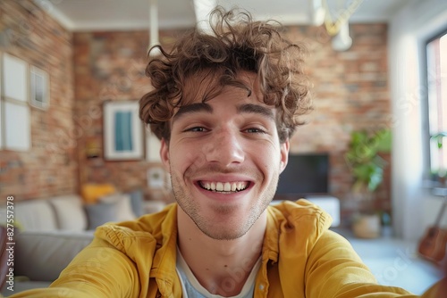happy young man taking selfie photo at home smiling millennial guy portrait