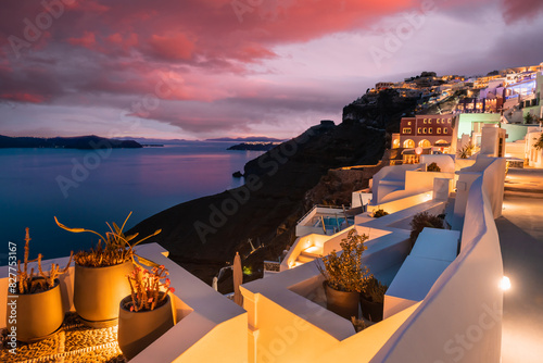 Night lights at sunset in Santorini island, Greece. White architecture with sea view in Fira town.