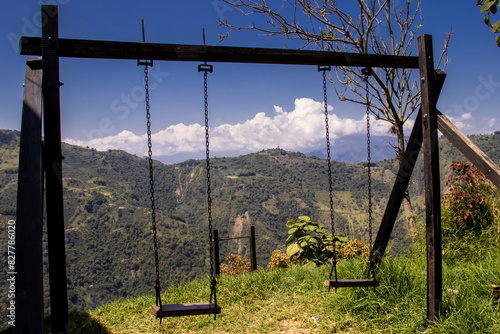 Empty wooden swings at the mountains in Colombia. Childhood concept. Loneliness concept.