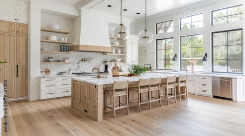 Light kitchen interior with a spacious layout, light wood flooring, and white cabinetry, creating a bright and welcoming atmosphere ideal for cooking and entertaining